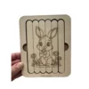 Puzzle bâtonnet lapin en bois tenu en main, montrant un jeu éducatif pour enfant favorisant la motricité fine et l’autonomie.