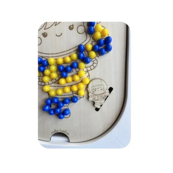 Insert sensoriel en bois -Zoom Cosmonaute à trous avec ses picots jaunes et bleus